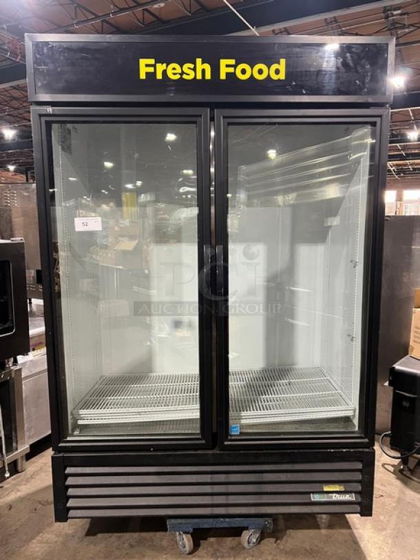 True Commercial Black Double Glass Swing Door Reach-In Merchandiser Refrigerator, Model GDM-49-HC~TSL01, Energy Star Certified, with poly coated wired racks, displayed in a warehouse setting.