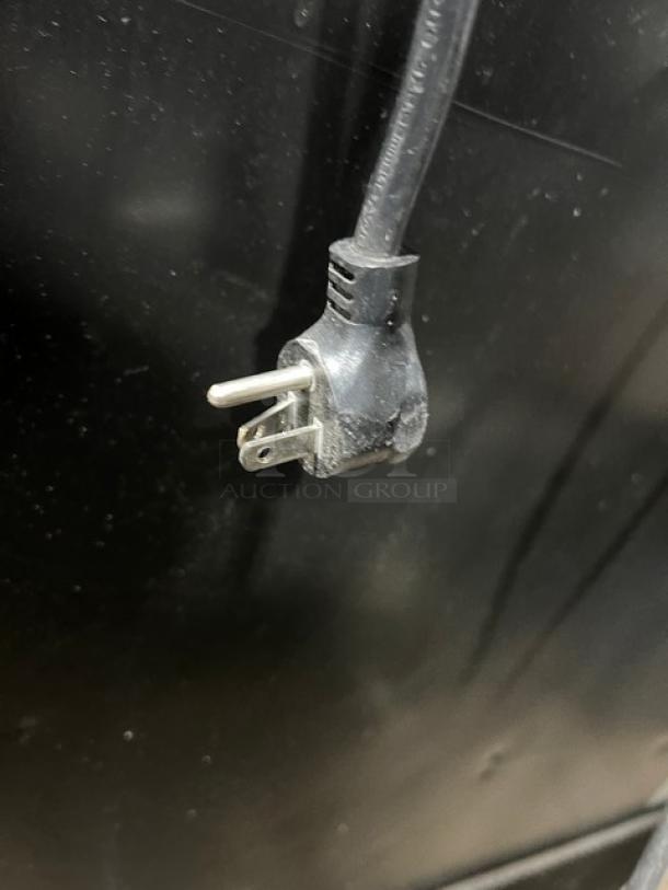 Close-up of a power plug for a True Commercial Double Glass Door Refrigerator, model GDM-49-HC~TSL01.