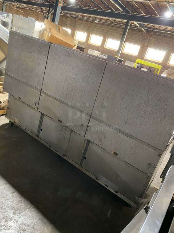 Vulcan commercial 8-burner gas range with split-top flat griddle, triple oven, backsplash, and wired oven rack on casters.