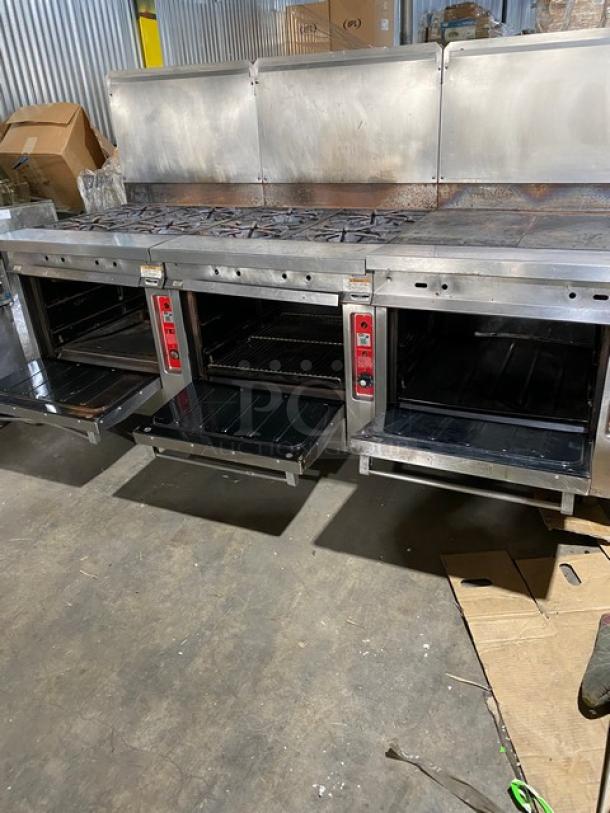Vulcan commercial stainless steel 8-burner gas range with split-top griddle, triple oven, backsplash, wired rack, on casters.