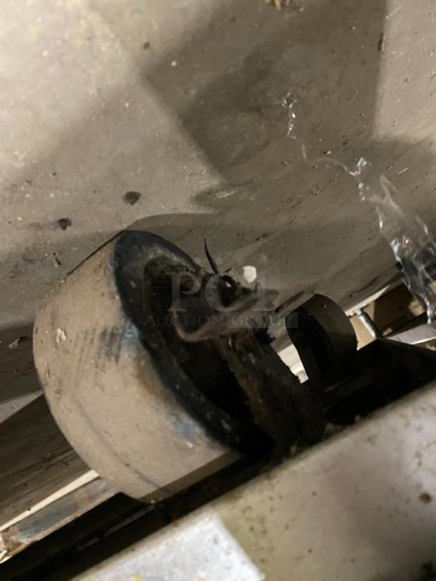 Vulcan range caster wheel, part of a gas-powered 8-burner griddle range with oven combo. Caster shows signs of wear.