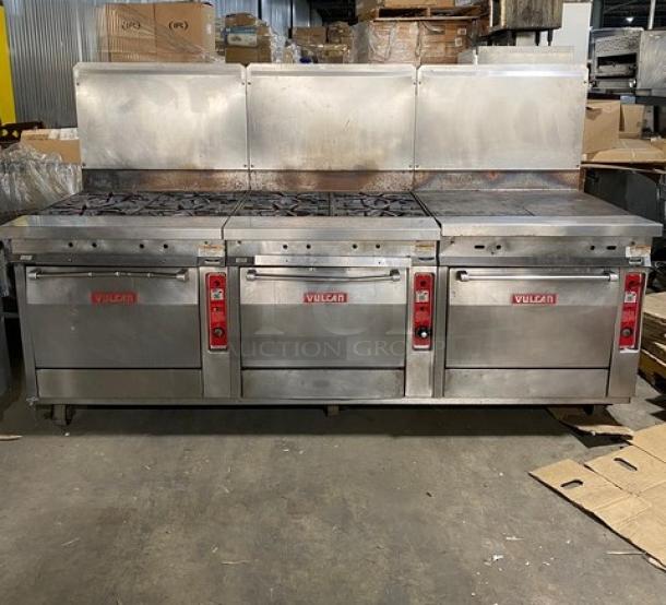Vulcan stainless steel gas 8-burner split-top flat griddle range with triple oven combo, backsplash, and casters. Includes wired oven rack.