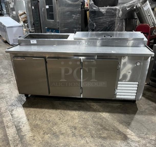 Universal Cooler stainless steel 3-door pizza prep table with poly coated wire rack on casters. Clean, good condition.