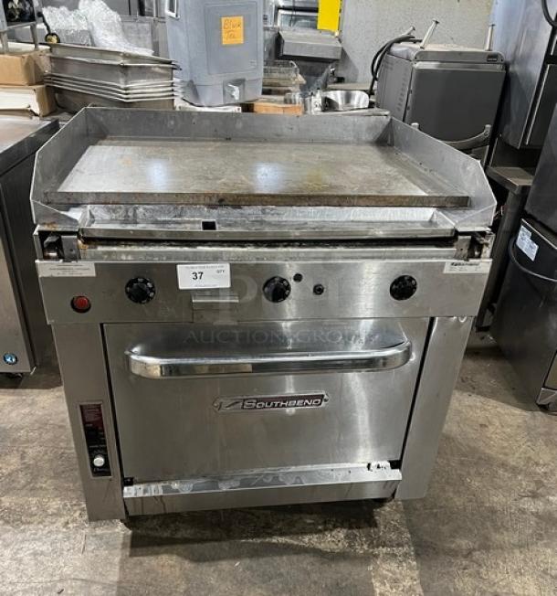 Southbend stainless steel natural gas flat-griddle top range & oven combo, Model P36ATTT, SN: 25B17419, on casters, with wired oven racks.