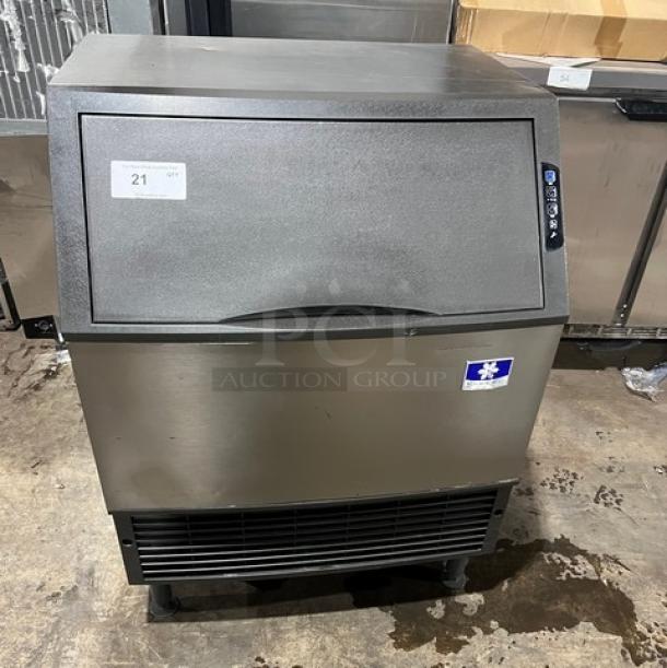 Manitowoc stainless steel undercounter ice machine, electric-powered, SN: 310466826, 115V, on legs, excellent condition.