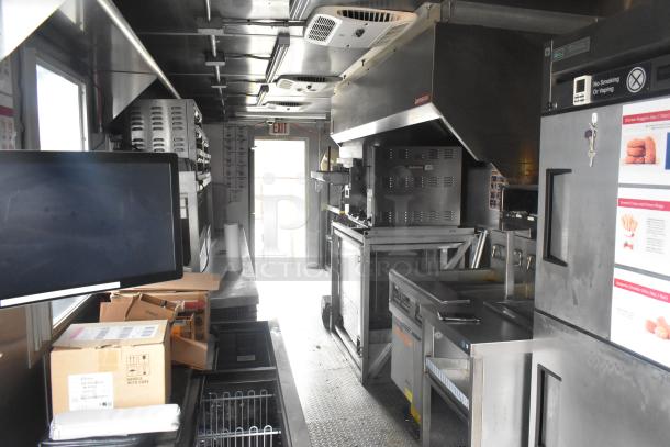 Modern 24' Burger King mobile kitchen trailer with stainless steel interior, CaptiveAire hood, Nieco grill, True freezers, and Frymaster fryer.