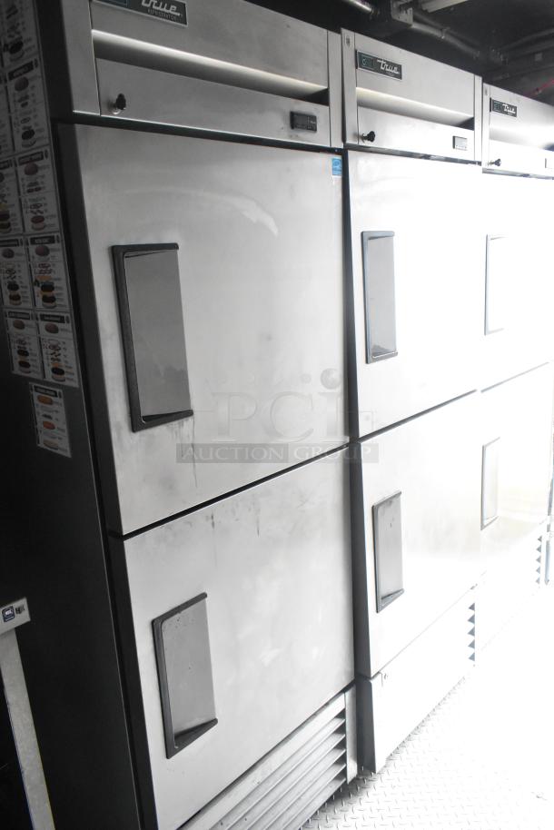 True commercial refrigerators inside a 24' Cruising Kitchens Burger King mobile kitchen trailer.