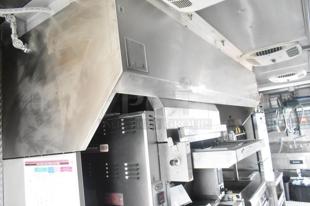 Burger King mobile kitchen interior with CaptiveAire hood, Nieco charbroiler, commercial stainless steel fixtures.