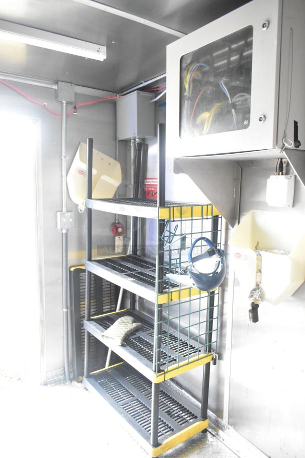 Interior of 24' Cruising Kitchens Burger King trailer with shelving, safety station, and electrical setup. Ready for use.