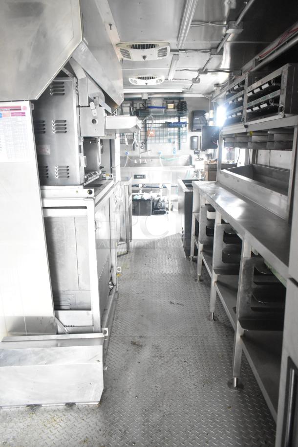 Interior of 24' Cruising Kitchens Burger King trailer, fully equipped with commercial appliances like CaptiveAire hood and Nieco grill.