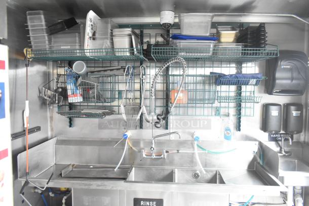 Cruising Kitchens 24' Burger King mobile kitchen interior. Features stainless steel sinks, shelving, commercial equipment.