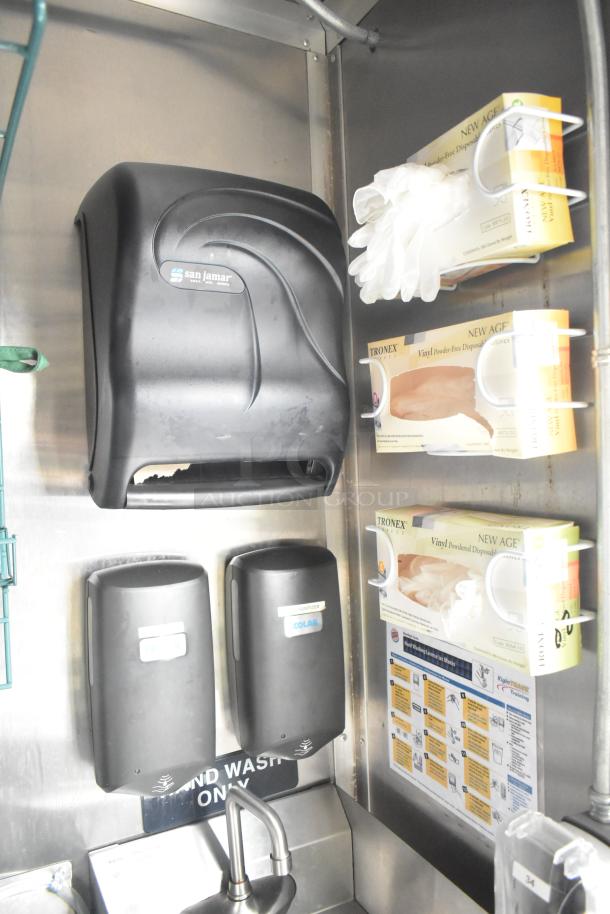 San Jamar paper towel dispenser, Trionex vinyl glove boxes, and Colab soap sanitizer dispensers in a Burger King trailer.