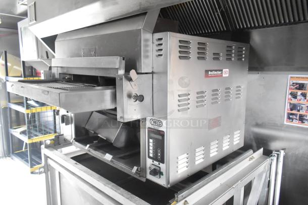 Nieco Charbroiler Grill in new condition, housed in a 24' Cruising Kitchens fast food trailer with commercial-grade equipment.