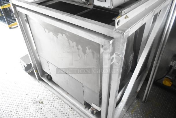 Cruising Kitchens 24' food trailer interior, featuring a stainless steel equipment setup on a diamond-plate floor.