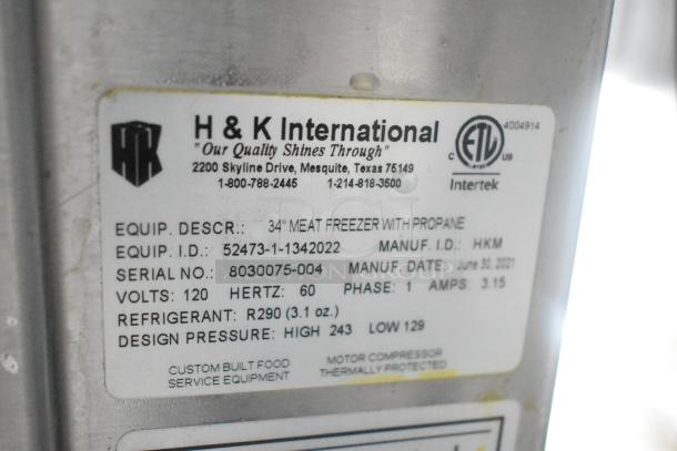 Label from H & K International showing specifications of 34" meat freezer with propane, serial number 8030075-004.