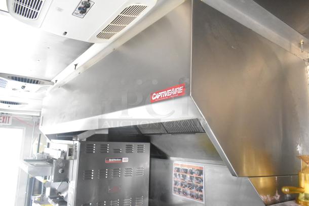 Cruising Kitchens 24' Burger King mobile kitchen interior showing CaptiveAire grease hood and Nieco charbroiler grill.