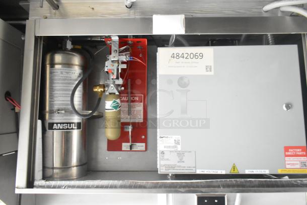 Mobile kitchen fire suppression system by Ansul, featuring a CaptiveAire grease hood and control panel, inside a food trailer.