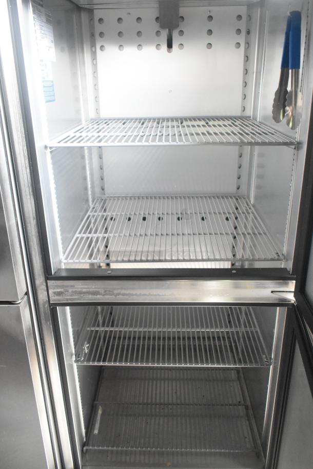 True reach-in cooler interior with empty wire shelves, showcasing ample storage space. Stainless steel finish, pristine condition.