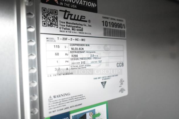 Label on True refrigerator model T-23F-2-HC-MC showing specifications like voltage, refrigerant type, and pressures.