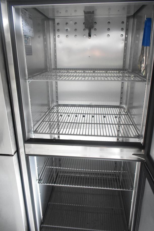 Inside view of a commercial-grade True reach-in cooler, featuring multiple metal shelves and a sleek stainless steel interior.