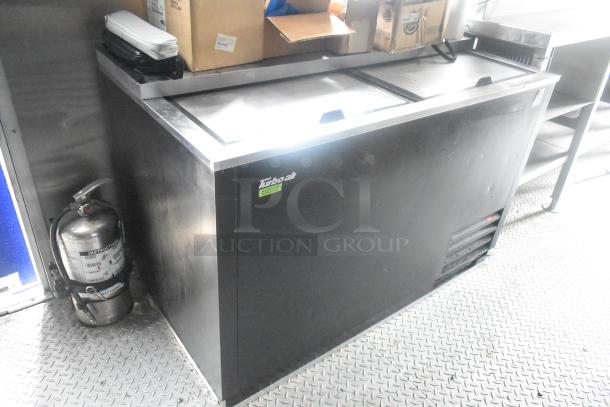 Turbo Air cooler inside a 24' Cruising Kitchens Burger King fast food trailer. Includes fire extinguisher, boxes atop.