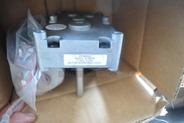Electric motor labeled "20786ND, 24VDC, 9.5RPM" inside box; wires and components visible.