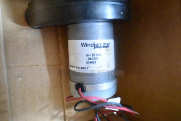 Motor with label reading "Windjammer 19-28 VDC 17NOV20 004893," featuring red and black wires.