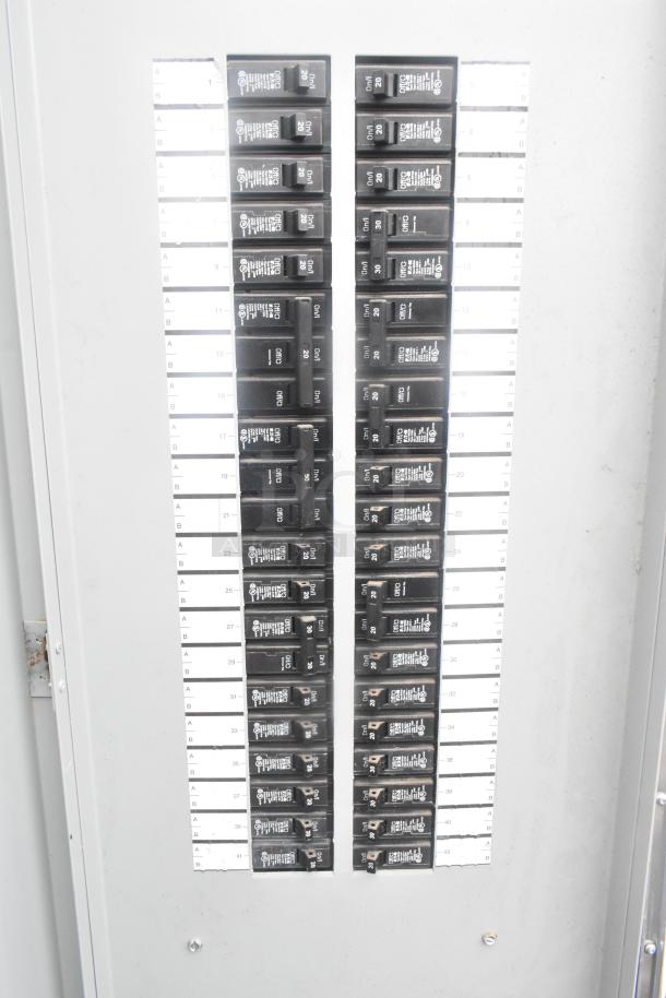 Electrical panel in Cruising Kitchens 24' Burger King trailer with numbered circuit breakers for various equipment.