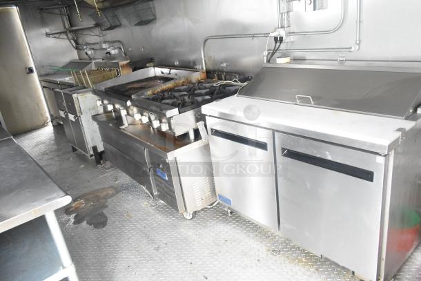 ATX 24' food trailer with commercial-grade kitchen, including grease hood, fire suppression, Royal gas range, Arctic Air prep tables.