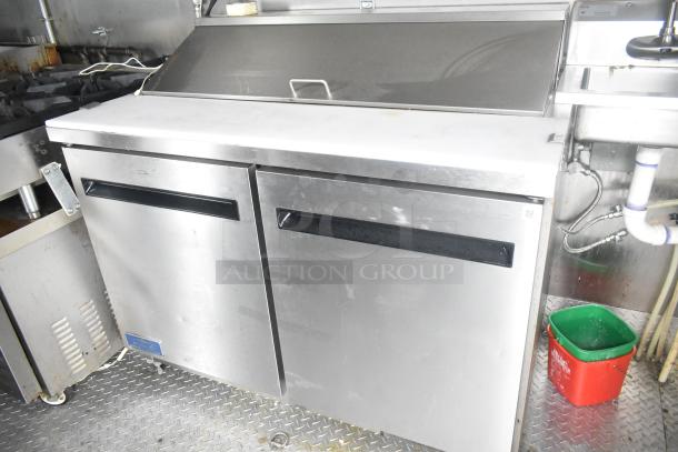 ATX 24' food trailer interior with Arctic Air prep table. Features stainless steel finish, dual doors, and overhead hood.