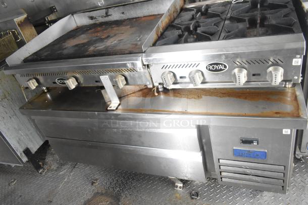 ATX food trailer interior featuring a Royal gas range and flat top grill with commercial-grade equipment, minor wear visible.