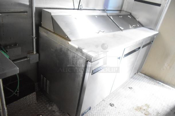 ATX 24' food trailer interior, featuring stainless steel Arctic Air prep tables in excellent condition.