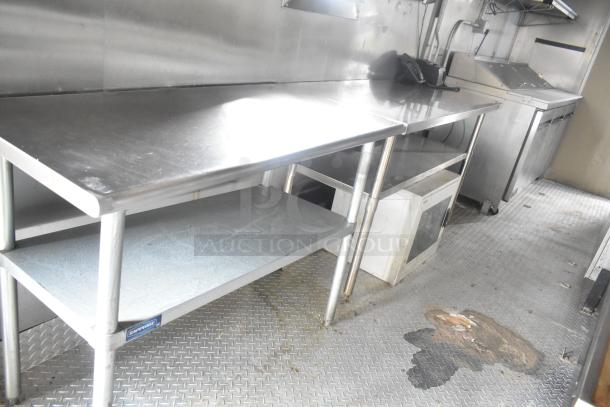 ATX 24' food trailer interior with stainless steel prep tables, commercial equipment, and diamond plate flooring.