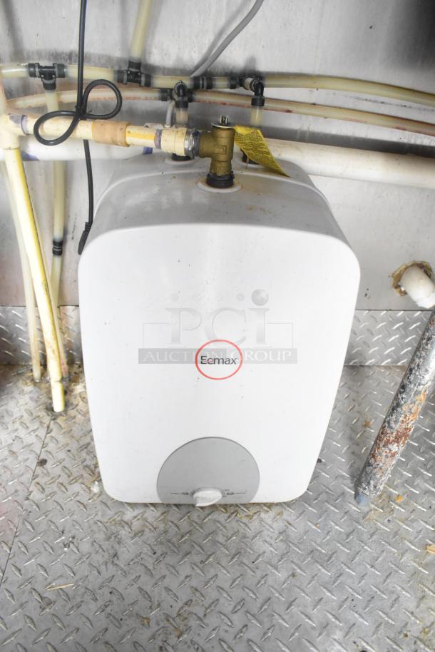 Eemax water heater in ATX 24' food trailer, installed with plumbing connections. Clean condition on metal flooring.