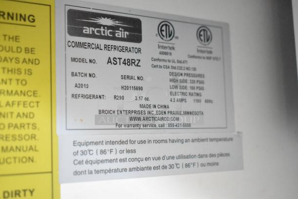 Arctic Air commercial refrigerator label, Model AST48RZ, featuring design pressures, refrigerant info, and contact details.