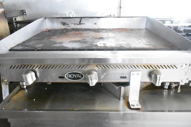 Royal gas flat top griddle in an ATX 24' food trailer. Features durable controls, robust build quality; good condition.
