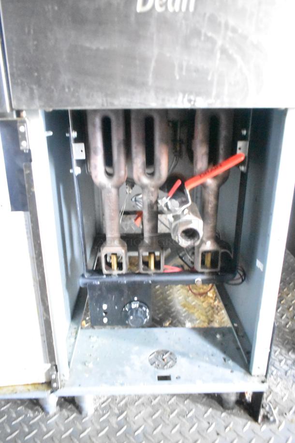 Interior view of a commercial gas range within an ATX 24' food trailer, showing burner assembly and control knobs.