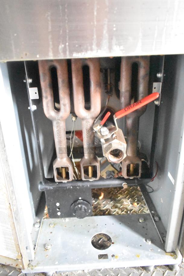 Interior view of ATX 24' food trailer's commercial equipment, showing grease hood and gas lines with drain valve.