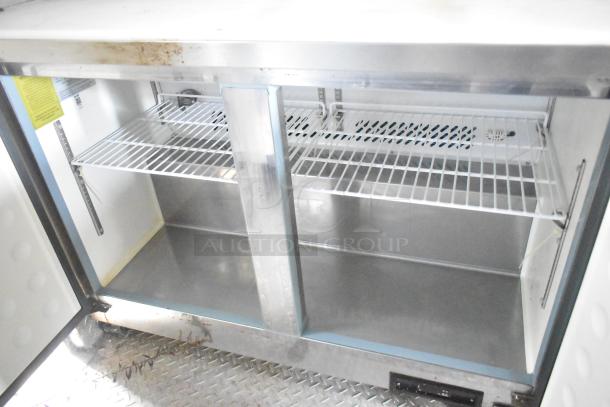 Interior of ATX 24' food trailer showing clean stainless steel Arctic Air prep tables with wire shelving and ventilation.