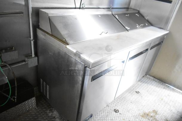 ATX 24' food trailer interior, featuring Arctic Air prep tables and stainless steel surfaces, in excellent condition.