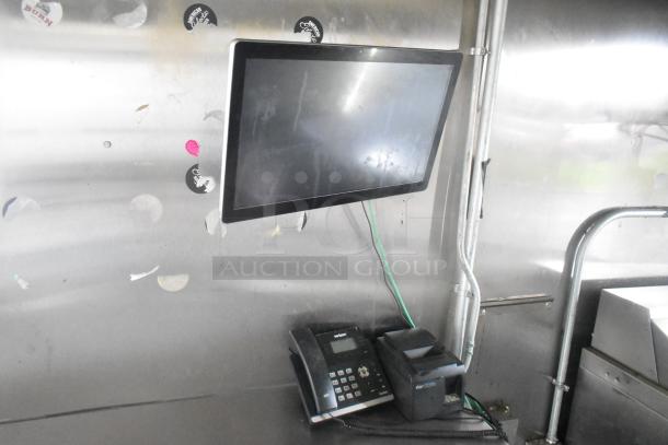 ATX 24' food trailer interior showing a mounted screen, phone, and Star printer on a stainless steel wall.