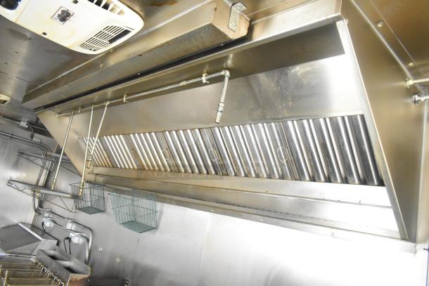 ATX 24' food trailer interior with commercial-grade grease hood and fire suppression system, 2021 model, pristine condition.