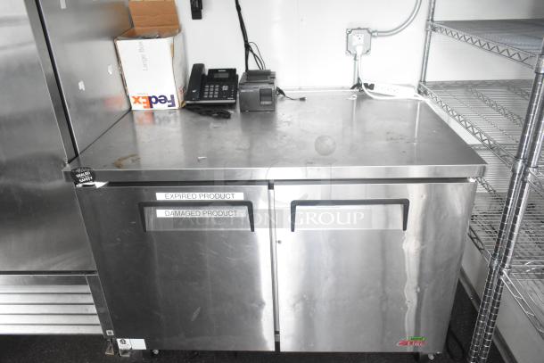 Southern Dimensions cold food trailer interior showing a stainless steel commercial cooler with "EXP-RIRED PRODUCT" and "DAMAGED PRODUCT" labels, wire shelving, and FedEx box.