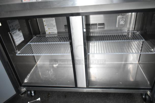 Stainless steel interior of a Southern Dimensions trailer with wire shelving, part of a commercial kitchen setup.