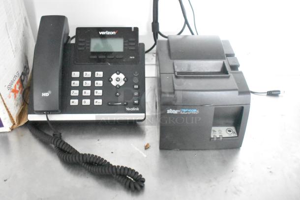 Office setup with a Verizon-branded Yealink T41S HD phone and a Star TSP100III futurePRNT receipt printer on a metal surface.