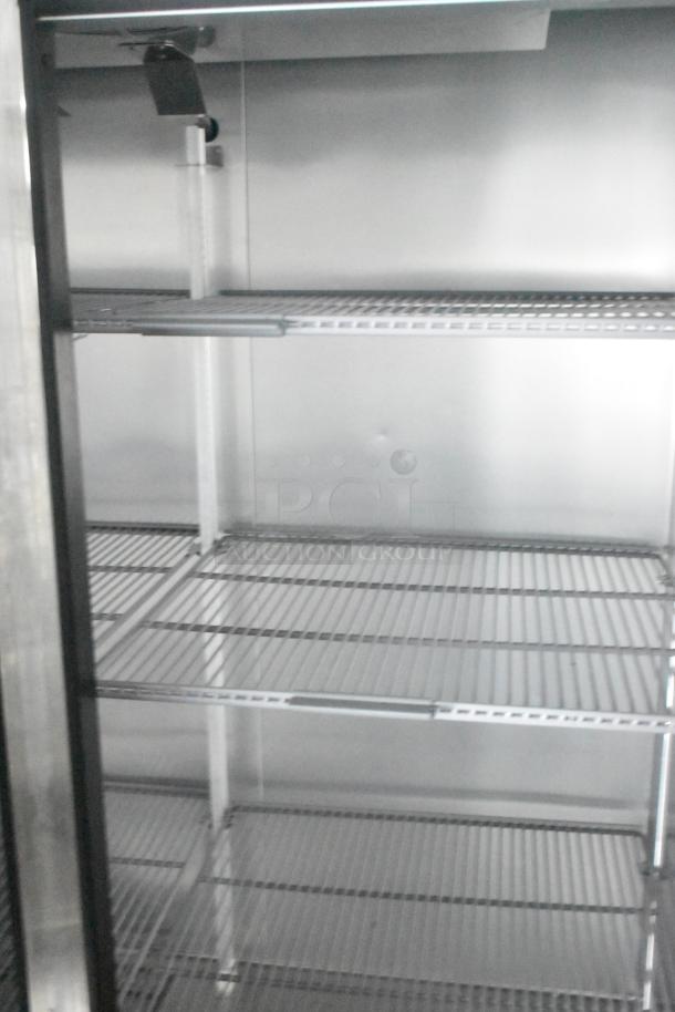 Interior of Southern Dimensions cold food and beverage trailer featuring wire shelving and stainless steel finish.
