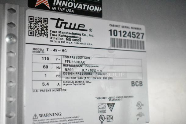 Label on True T-49-HC cooler showing model, refrigerant R290, design pressures, and energy certification details.