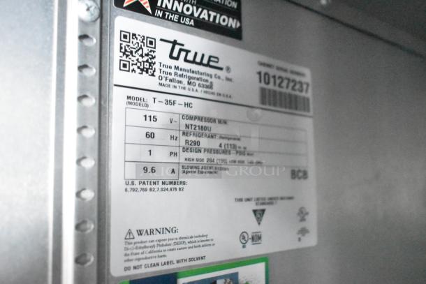 Label on True reach-in cooler, model T-35F-HC, showing specifications: 115V, 60Hz, R290 refrigerant, compressor NT2180U.