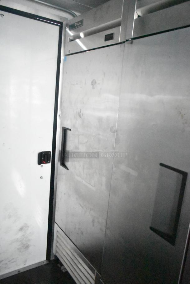 Southern Dimensions 24' cold food and beverage trailer interior showing True reach-in coolers and door.