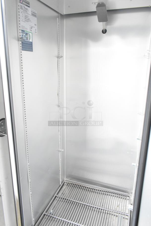 Interior of Southern Dimensions 24' cold food trailer showing a True commercial grade cooler, stainless steel interior, and wire shelving.